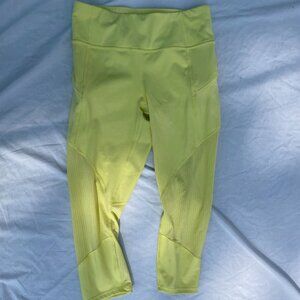 Athleta lemon yellow cropped leggings. Side zip pockets and mesh panels